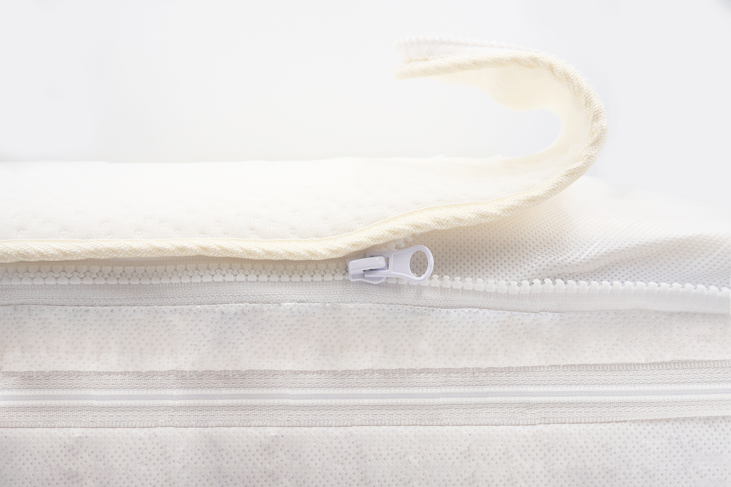 Coolmax topper being unzipped from the mattress